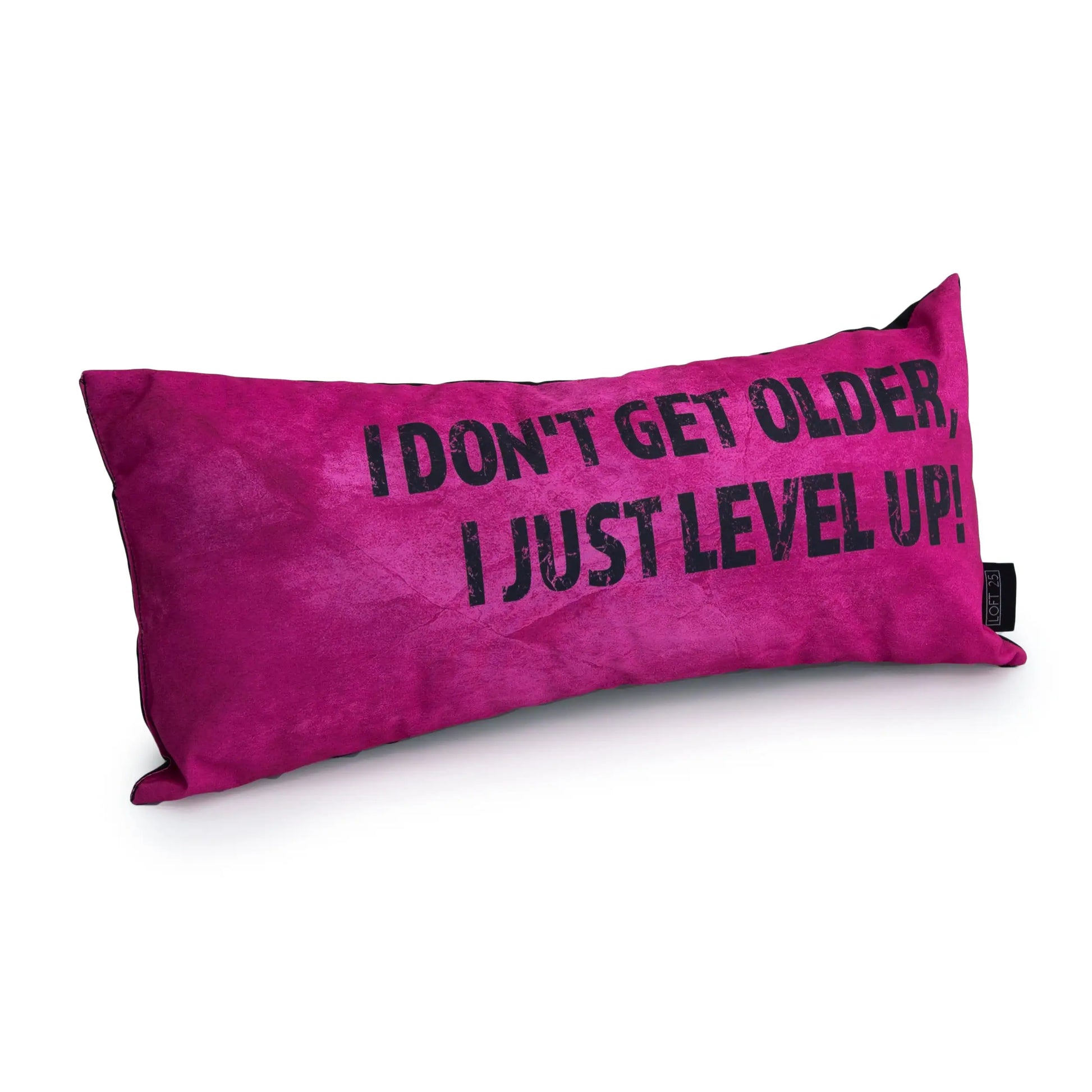 A pink rectangular pillow with the text "I don't get older, I just level up."