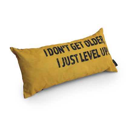 A yellow rectangular pillow with the text "I don't get older, I just level up."