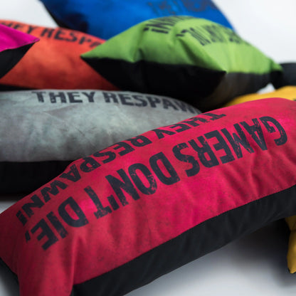  stack of colorful pillows with a message of hope for gamers: "GAMERS DON'T DIE THEY RESPAWN."